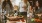 a group of women stand around a table with food